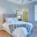 a bedroom with a bed and a fan