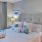 a bedroom with a bed and a fan