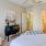 a bedroom with a bed and a fan